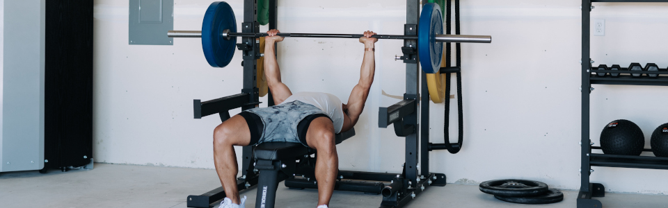 Man Powerlifting at Home With Torque Equipment Lifting Rack